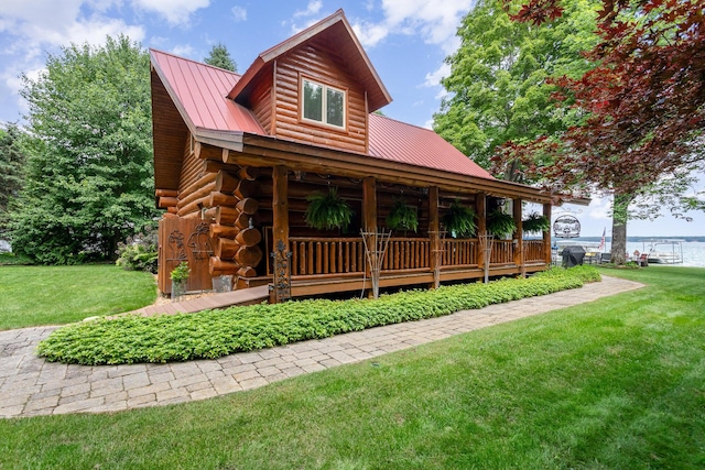 23 Treasure Is, Roscommon, MI 48653 - log home featuring a front lawn, log exterior, a porch, and a metal roof