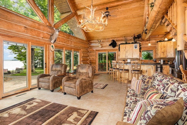 23 Treasure Is, Roscommon, MI 48653 - living area with a chandelier, healthy amount of natural light, light tile patterned floors, log walls, and a water view