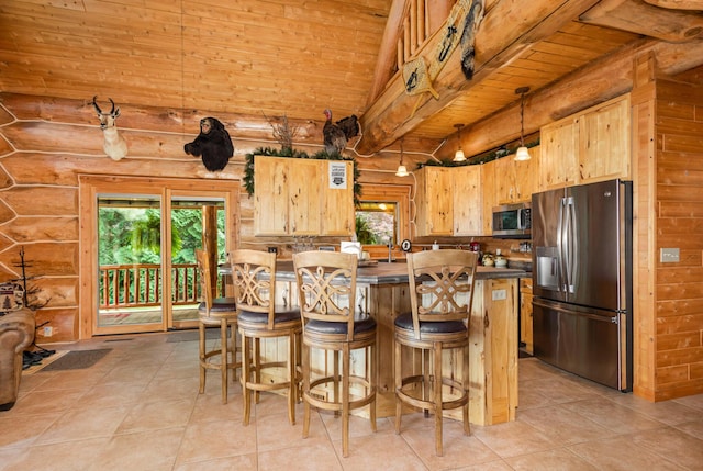 23 Treasure Is, Roscommon, MI 48653 - kitchen with stainless steel appliances, a wooden ceiling with exposed beams, rustic walls, healthy amount of natural light, and light tile patterned floors