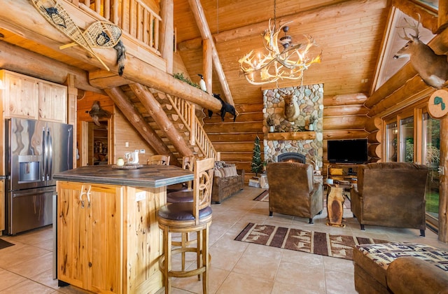 23 Treasure Is, Roscommon, MI 48653 - kitchen featuring stainless steel fridge with ice dispenser, rustic walls, a wood ceiling with exposed beams, dark countertops, and light tile patterned floors