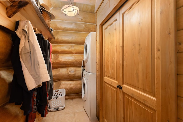 23 Treasure Is, Roscommon, MI 48653 - laundry room with rustic walls, stacked washer / dryer, and light tile patterned flooring