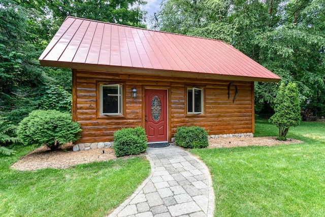 23 Treasure Is, Roscommon, MI 48653 - cabin with a standing seam roof, a metal roof, a front yard, and an outdoor structure