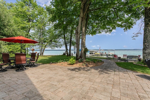 23 Treasure Is, Roscommon, MI 48653 - view of patio / terrace with a water view and outdoor dining space