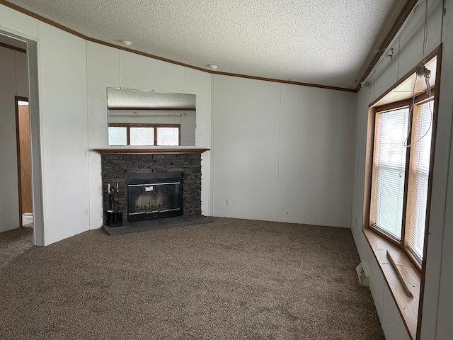 2503 W Hubbard Lake Trl, Hubbard Lake, MI 49747 - unfurnished living room featuring a textured ceiling, ornamental molding, a stone fireplace, lofted ceiling, and a decorative wall