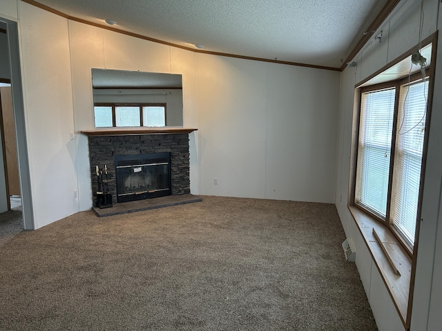 2503 W Hubbard Lake Trl, Hubbard Lake, MI 49747 - unfurnished living room featuring a textured ceiling, carpet, a stone fireplace, and crown molding