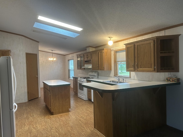 2503 W Hubbard Lake Trl, Hubbard Lake, MI 49747 - kitchen with white appliances, light wood-style floors, lofted ceiling, crown molding, and a center island