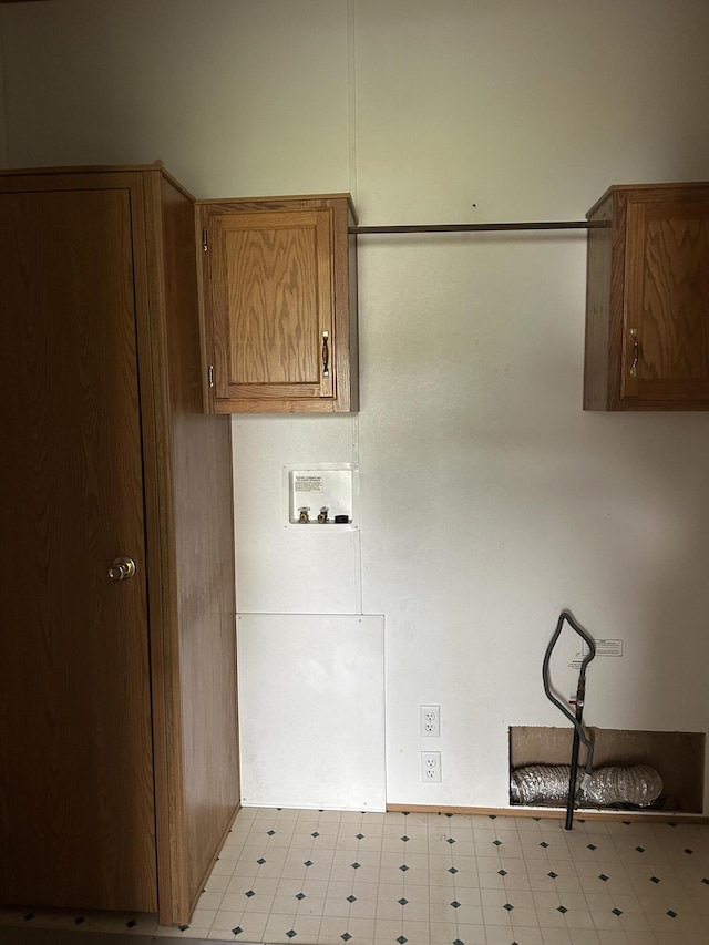2503 W Hubbard Lake Trl, Hubbard Lake, MI 49747 - laundry room with cabinet space, washer hookup, and tile patterned floors