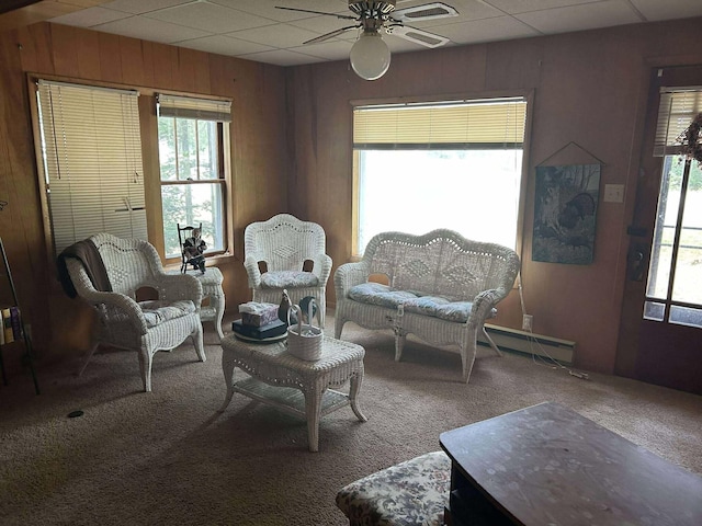 302 S Vine St, Mio, MI 48647 - living room with ceiling fan, carpet flooring, plenty of natural light, and wooden walls