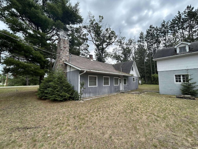 302 S Vine St, Mio, MI 48647 - view of front of property with a front yard and a chimney