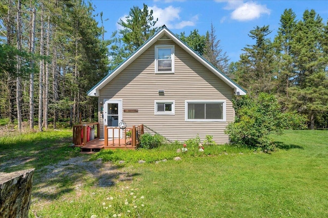 2951 N Palmer Rd, Onaway, MI 49765 - rear view of property featuring a deck and a yard