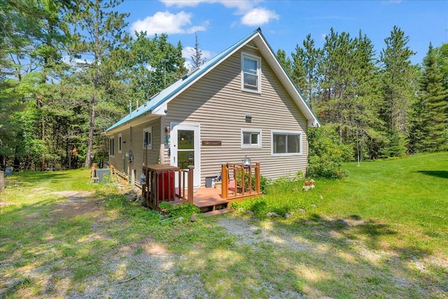 2951 N Palmer Rd, Onaway, MI 49765 - back of property with a lawn and a deck