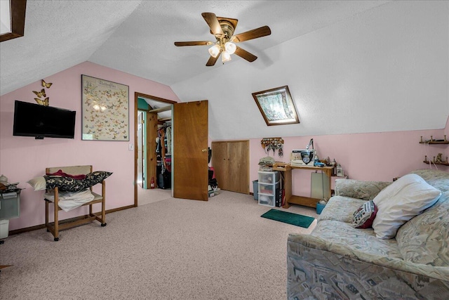 2951 N Palmer Rd, Onaway, MI 49765 - living area featuring lofted ceiling, carpet floors, a ceiling fan, and a textured ceiling