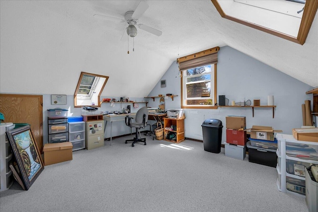 2951 N Palmer Rd, Onaway, MI 49765 - office area featuring carpet floors, vaulted ceiling, a skylight, ceiling fan, and a textured ceiling