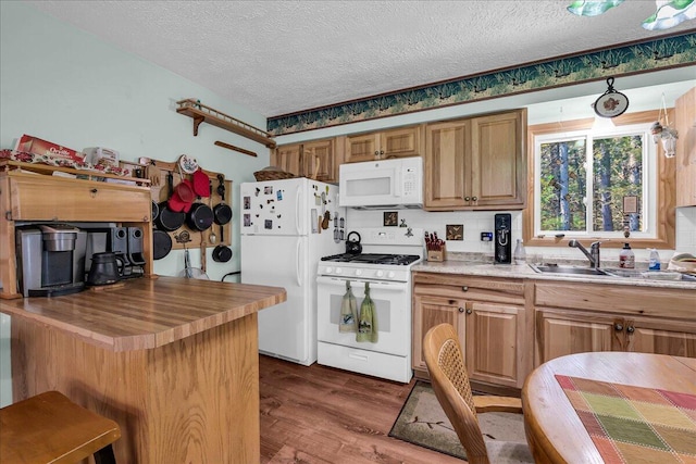 2951 N Palmer Rd, Onaway, MI 49765 - kitchen with white appliances, a textured ceiling, wooden counters, dark wood-style flooring, and brown cabinets