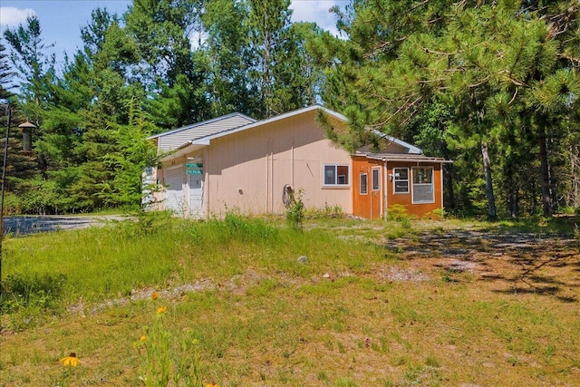 2951 N Palmer Rd, Onaway, MI 49765 - view of property exterior with a garage