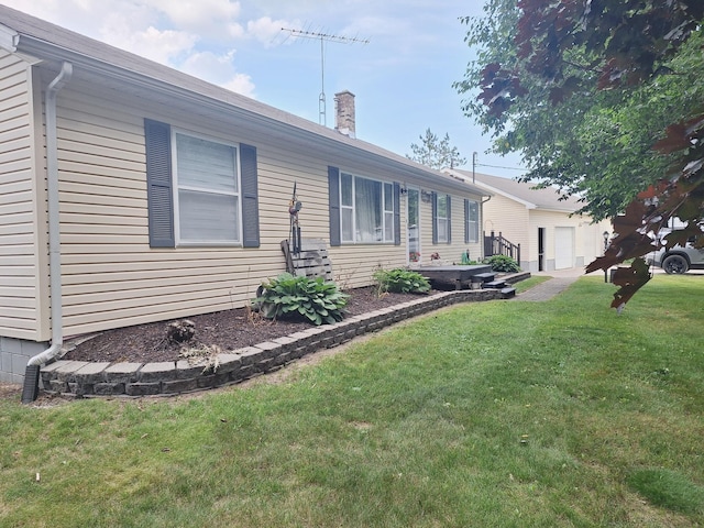 13631 Tolan Rd, Ossineke, MI 49766 - view of home's exterior with a chimney and a yard