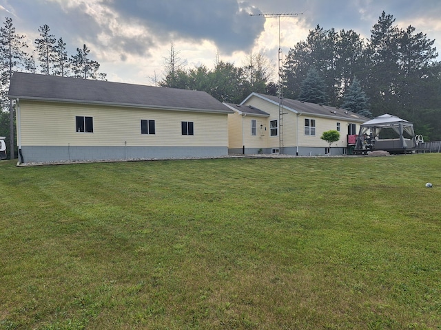 13631 Tolan Rd, Ossineke, MI 49766 - rear view of property with a gazebo and a lawn