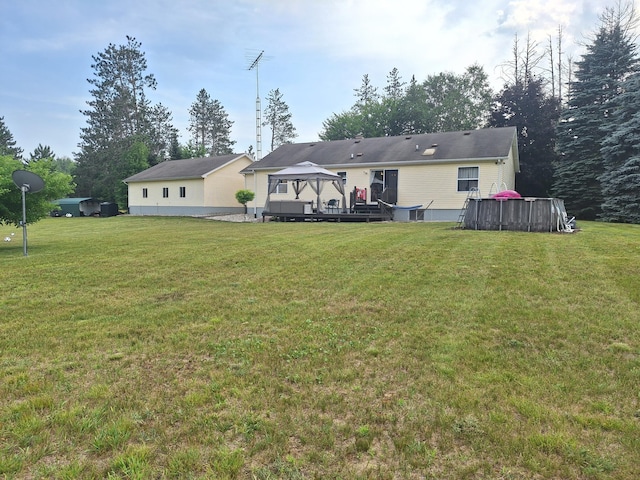 13631 Tolan Rd, Ossineke, MI 49766 - back of property featuring a gazebo, a lawn, and a deck