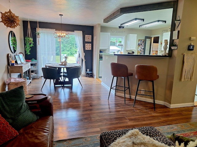 13631 Tolan Rd, Ossineke, MI 49766 - dining room with wood finished floors and a chandelier
