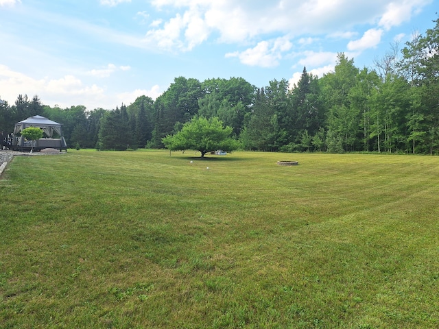 13631 Tolan Rd, Ossineke, MI 49766 - view of grassy yard with a gazebo and a wooded view