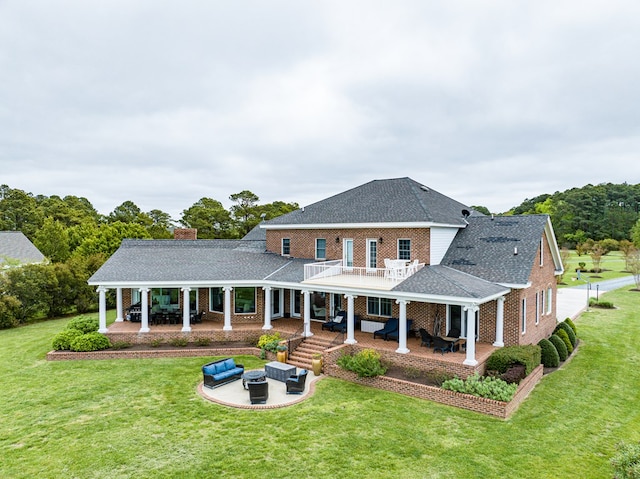 back of house featuring a lawn, a balcony, an outdoor hangout area, and a patio