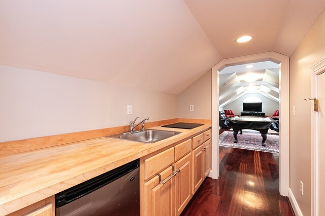 kitchen featuring light brown cabinetry, stainless steel dishwasher, vaulted ceiling, sink, and butcher block countertops