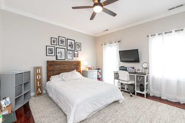 bedroom featuring hardwood / wood-style floors, ceiling fan, crown molding, and multiple windows