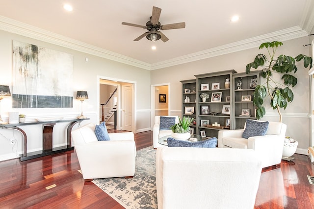 living room with dark hardwood / wood-style floors, ceiling fan, and ornamental molding