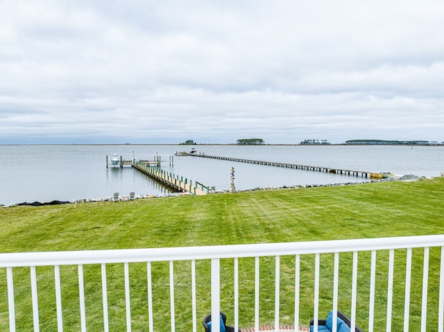 dock area featuring a water view and a yard