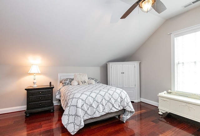 bedroom with ceiling fan, dark hardwood / wood-style flooring, and vaulted ceiling