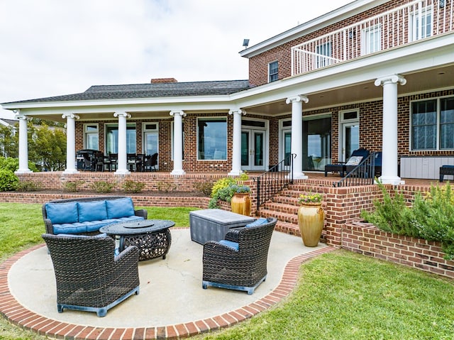 view of patio featuring a balcony and french doors