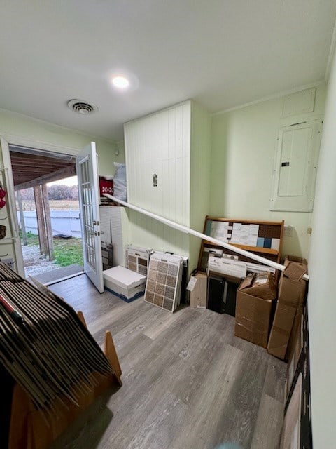 interior space with electric panel, light hardwood / wood-style flooring, and french doors