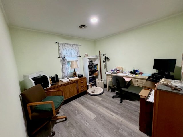 office area featuring light hardwood / wood-style floors and ornamental molding