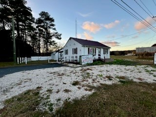 view of back house at dusk