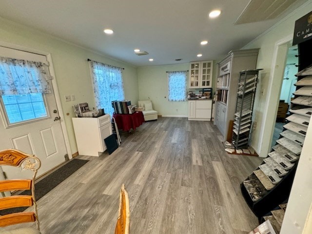 interior space with hardwood / wood-style flooring and crown molding