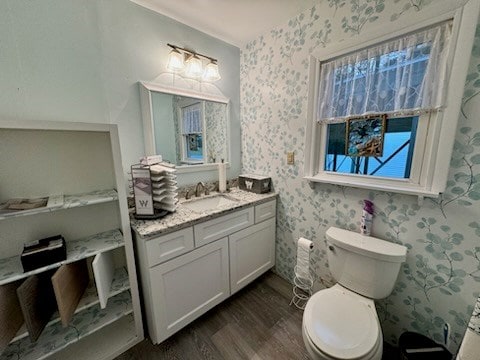 bathroom featuring hardwood / wood-style flooring, vanity, and toilet