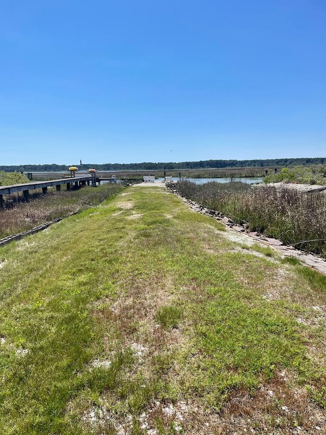 7669 E Side Rd, Chincoteague, VA 23336 - view of green lawn featuring a water view