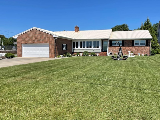 7669 E Side Rd, Chincoteague, VA 23336 - ranch-style home with a chimney, a garage, a front yard, and brick siding