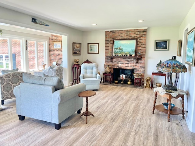 7669 E Side Rd, Chincoteague, VA 23336 - living room featuring wood finished floors, a brick fireplace, and recessed lighting