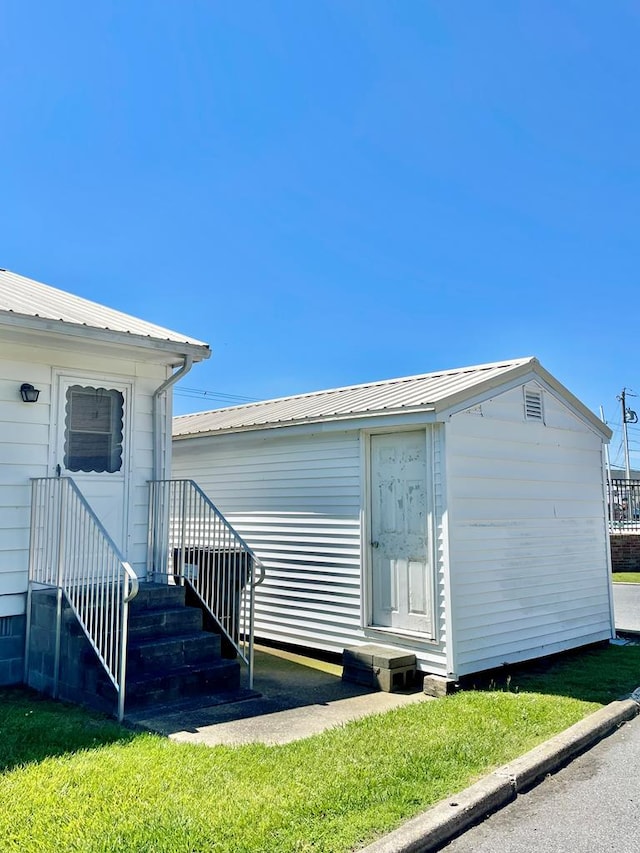 7669 E Side Rd, Chincoteague, VA 23336 - back of house with metal roof and an outbuilding