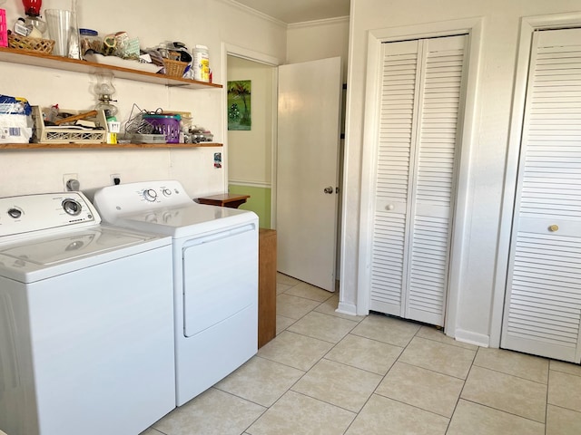7669 E Side Rd, Chincoteague, VA 23336 - washroom featuring washer and dryer, ornamental molding, and light tile patterned floors