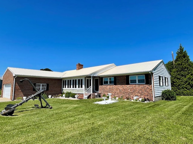 7669 E Side Rd, Chincoteague, VA 23336 - single story home with brick siding, a front yard, and a chimney