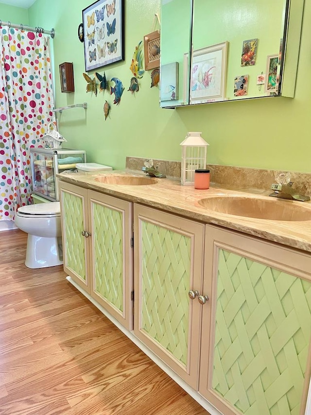 7669 E Side Rd, Chincoteague, VA 23336 - full bathroom featuring double vanity, toilet, wood finished floors, and a shower with curtain