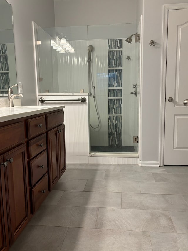 bathroom featuring vanity and an enclosed shower