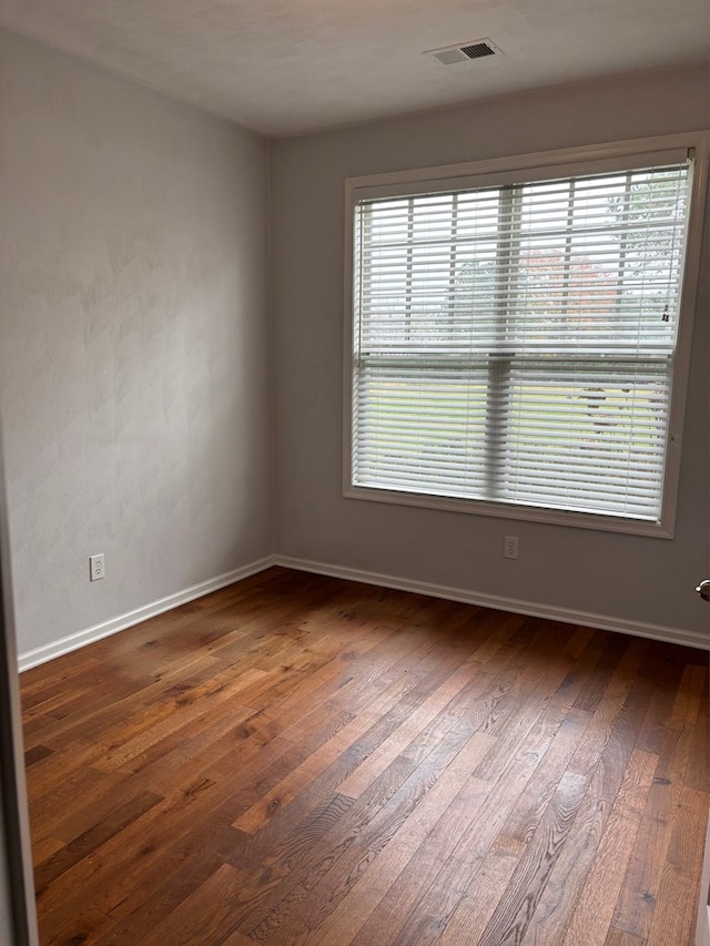 unfurnished room with dark hardwood / wood-style floors