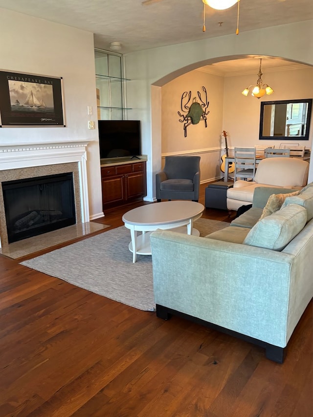 living room featuring a chandelier, a fireplace, and dark hardwood / wood-style flooring