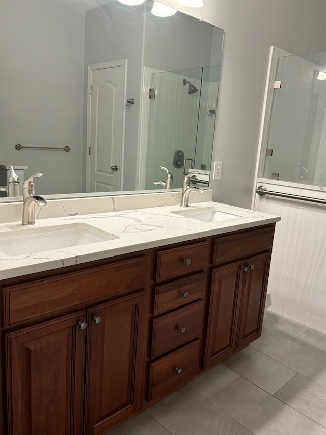 bathroom with vanity, tile patterned flooring, and a shower