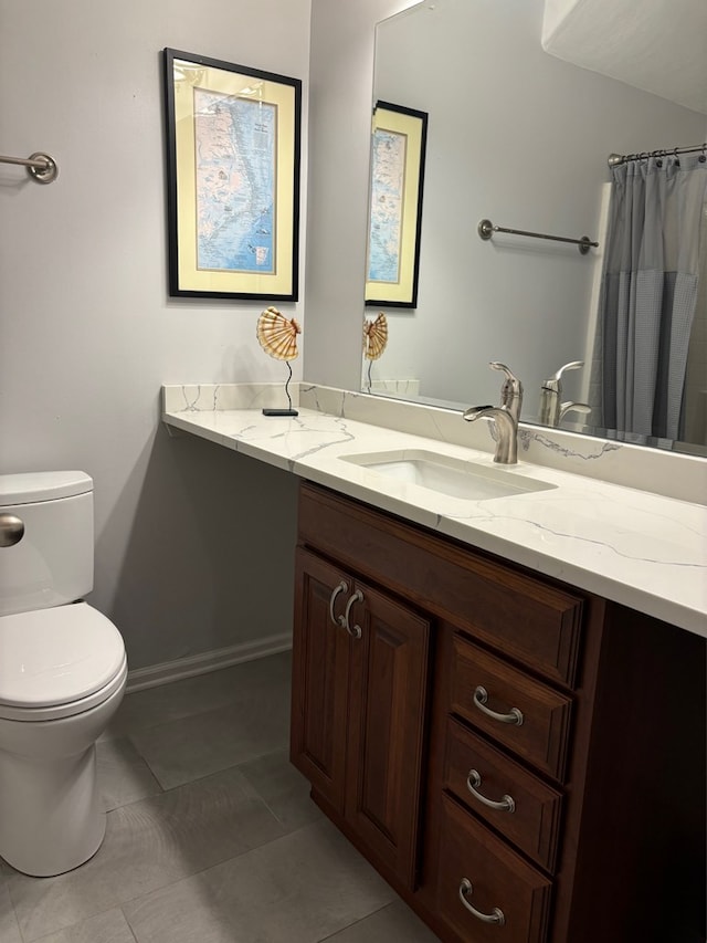 bathroom with vanity, tile patterned floors, and toilet