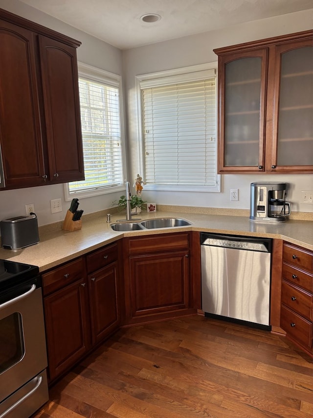 kitchen featuring dark hardwood / wood-style flooring, sink, and stainless steel appliances