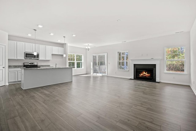 LOT476 Driftwood Dr, Greenbackville, VA 23356 - unfurnished living room featuring dark wood-style flooring, a fireplace with flush hearth, recessed lighting, baseboards, and a sink